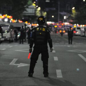 Police officers maintaining order during a night street patrol, ensuring public safety.